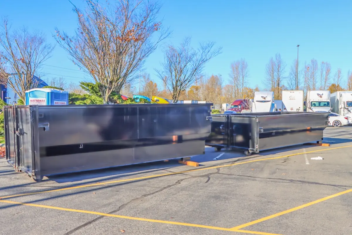 Professional dumpster rental service with roll-off container on residential driveway in Schuyler Falls
